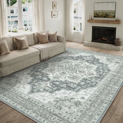 Traditional tartan rug, hand‑knotted wool, deep reds and greens, classic country lounge